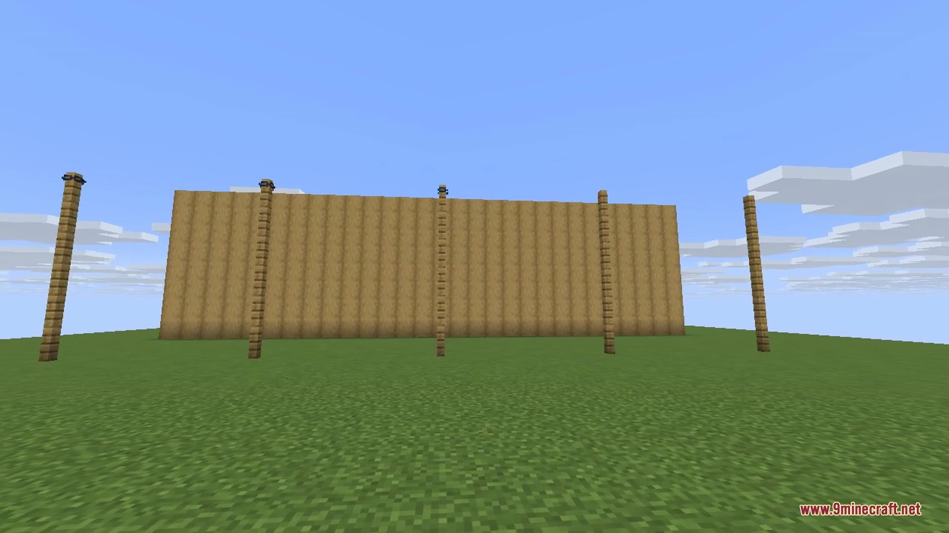Wooden fence posts connected by sagging iron chains on a stone brick platform
