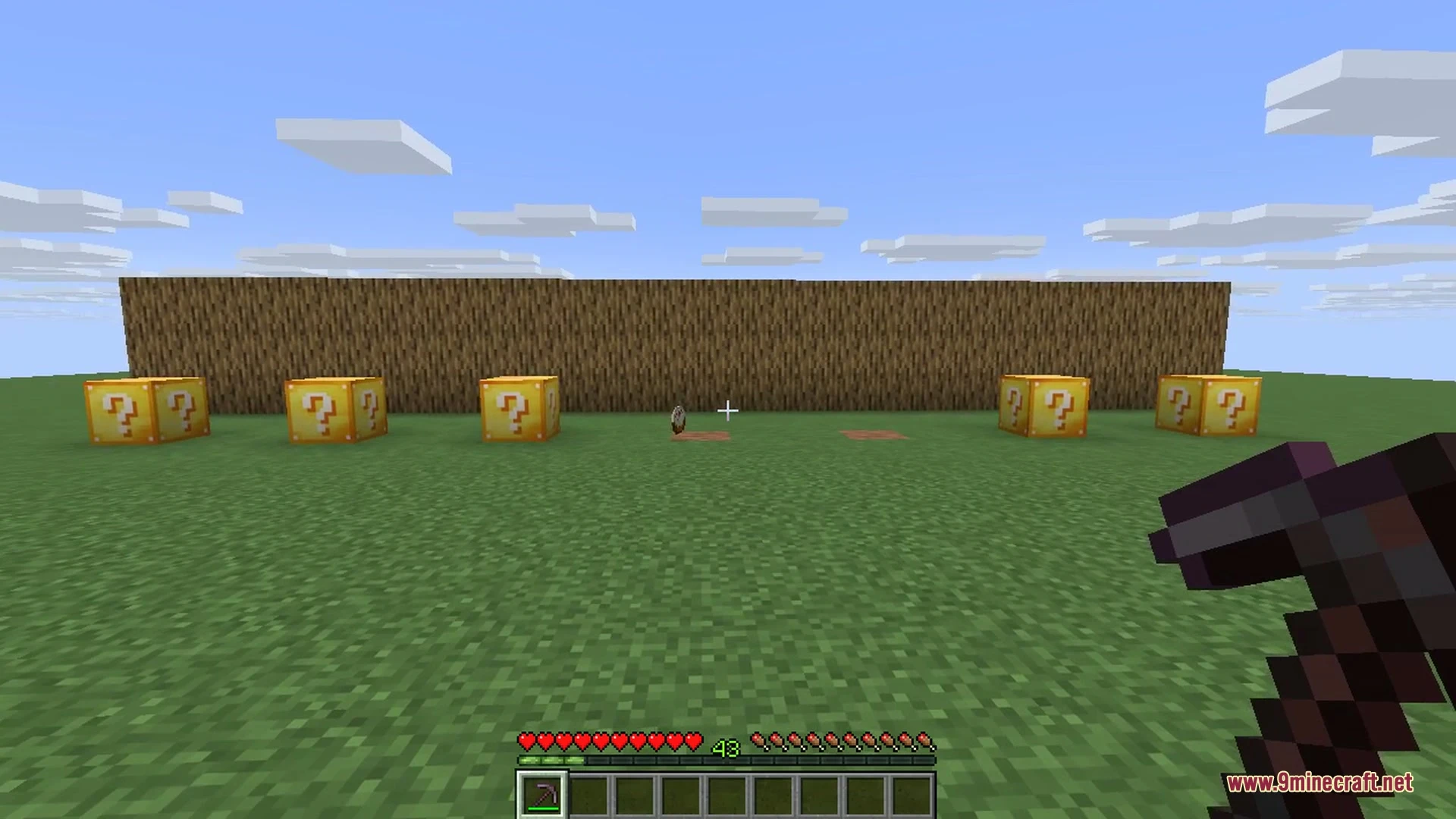 A player in diamond armor stands near a Lucky Block on tree leaves
